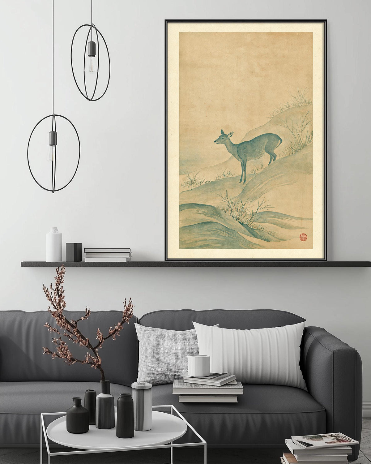 a living room with a gray sofa, a coffee table, and a large framed picture of a deer on the wall above the sofa.
