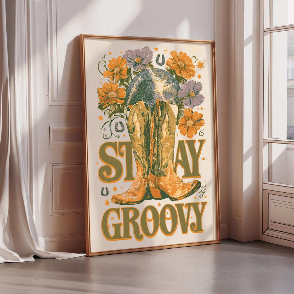 A framed poster with a vibrant design featuring a pair of yellow cowboy boots surrounded by flowers and the text "STAY GROOVY".