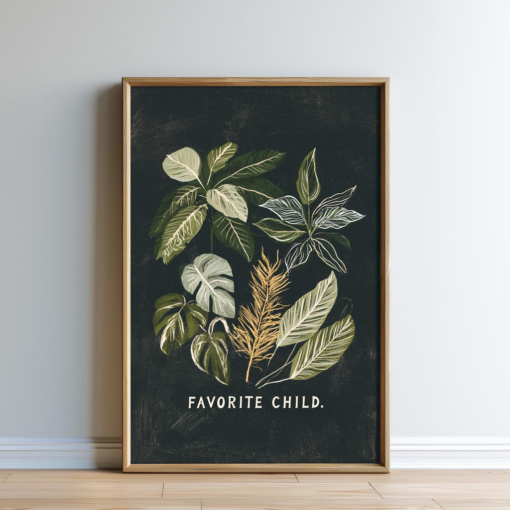 The image is a framed print featuring a black background with a collage of various green leaves and plants, along with the text "Favored Child."
