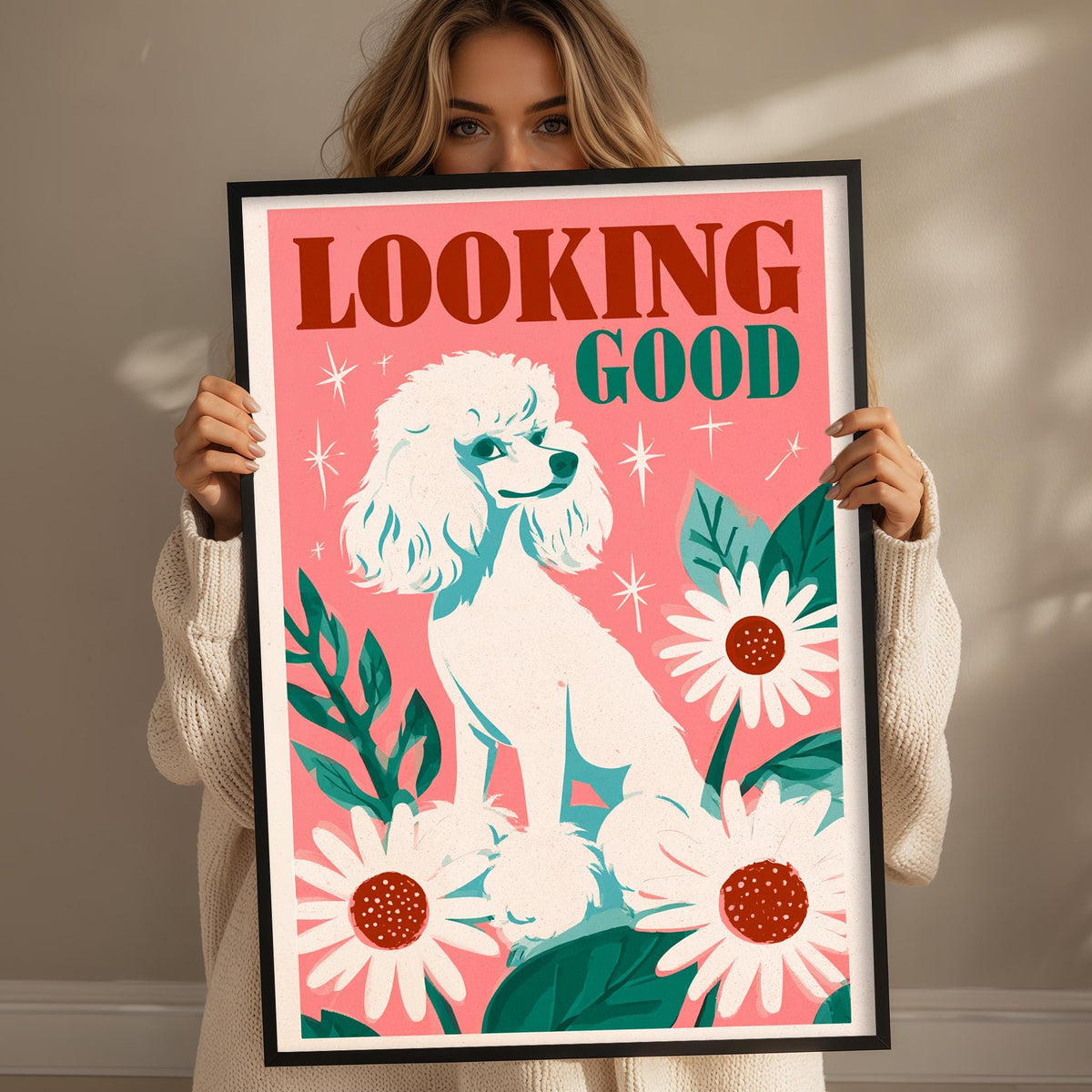 A woman holding a framed poster with a poodle and flowers on it.