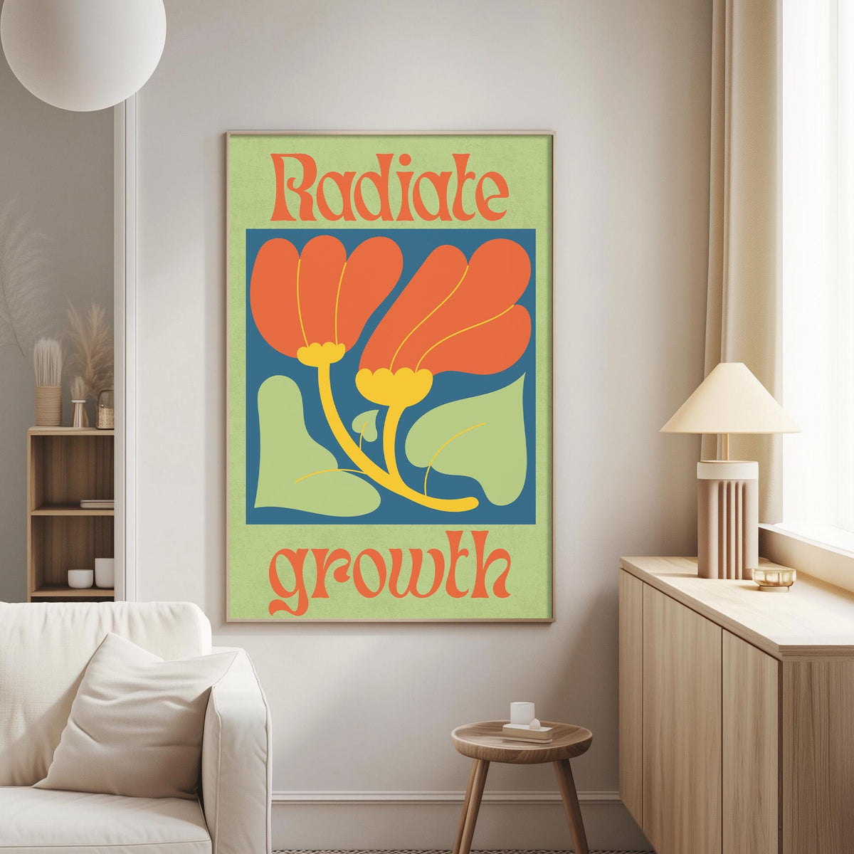 a poster with the text "RADIATE GROWTH" and an illustration of a flower with orange petals and green leaves. The poster is hanging on a wall in a living room setting, with a white couch and a small table nearby.