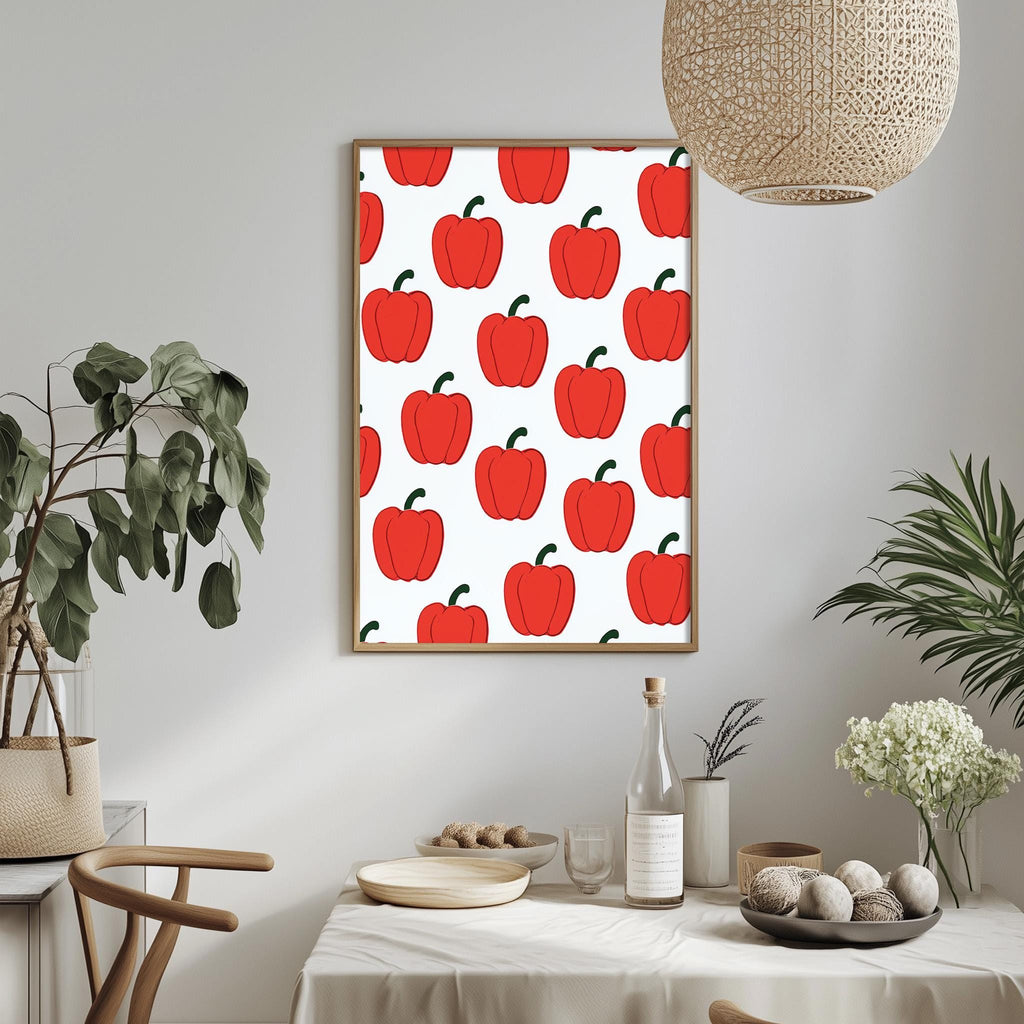 a dining table with a white tablecloth, a bowl of fruit, a bottle, and a vase with flowers. Above the table, there is a framed picture of red peppers on a white background.