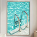 a large framed picture of a swimming pool with a ladder, hanging on a wall in a living room setting.