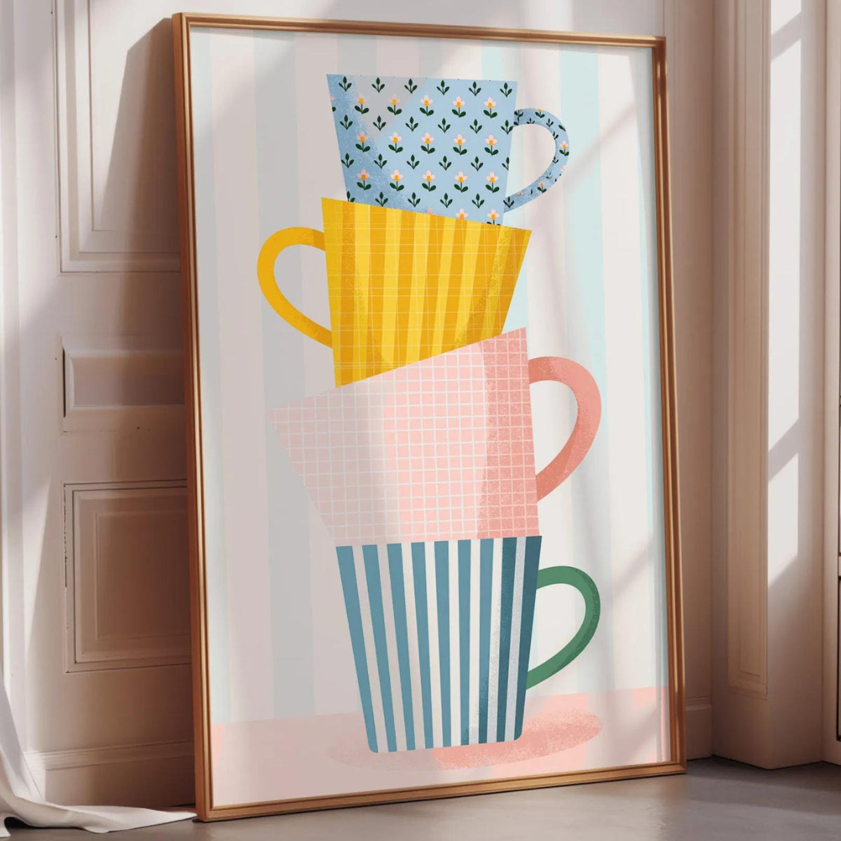 A framed poster featuring a stack of colorful coffee mugs with various patterns and designs.