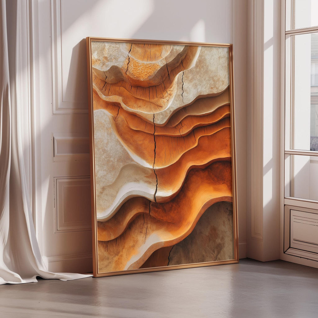 a large, framed artwork depicting a striking abstract design with a mix of orange and brown hues, creating a sense of depth and movement.