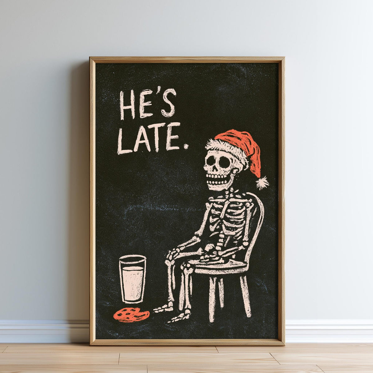 A skeleton wearing a Santa hat is sitting in a chair next to a glass of milk, with the text "HE'S LATE."