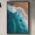 a kitchen counter with a framed picture of a surfer riding a wave, a wooden cutting board, and various kitchen items such as a bottle, a vase, and a bowl.