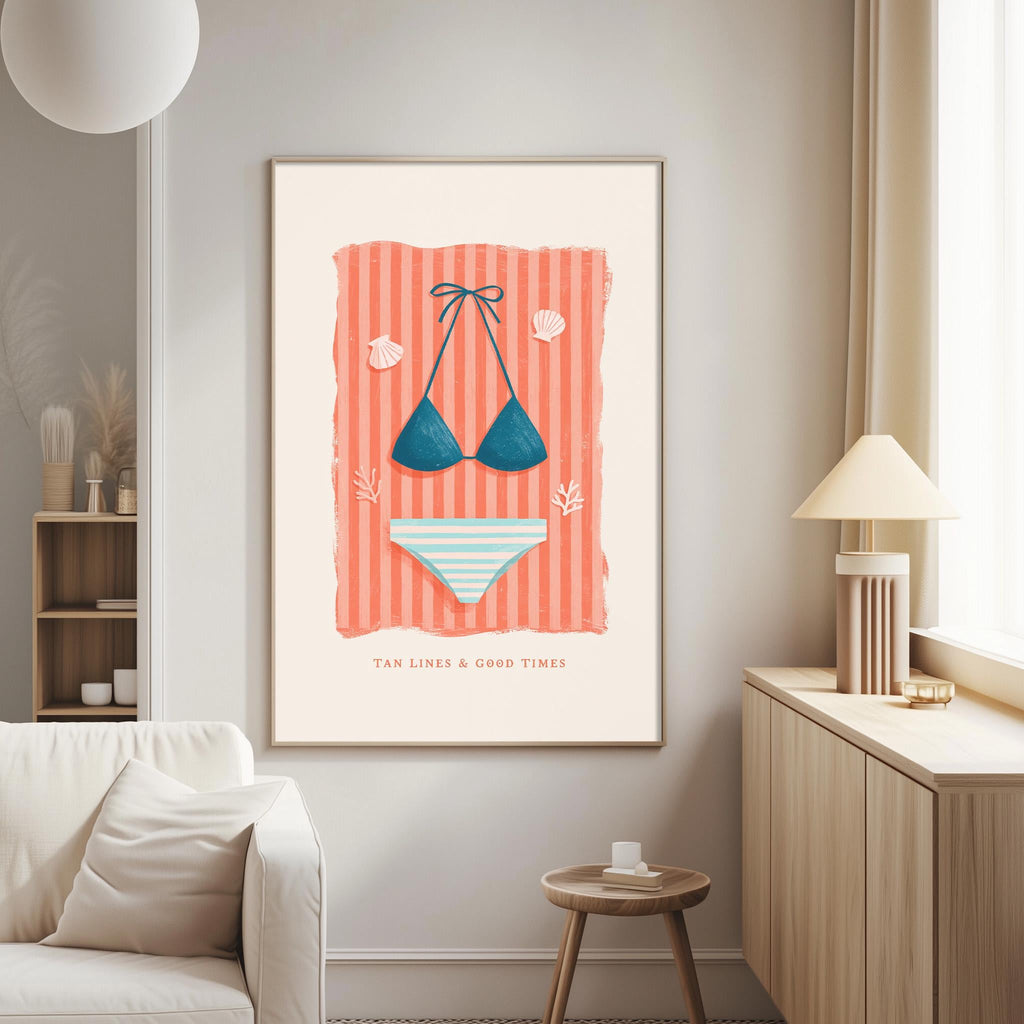 a framed poster of a bikini and striped bikini bottoms, hanging on a wall in a living room.