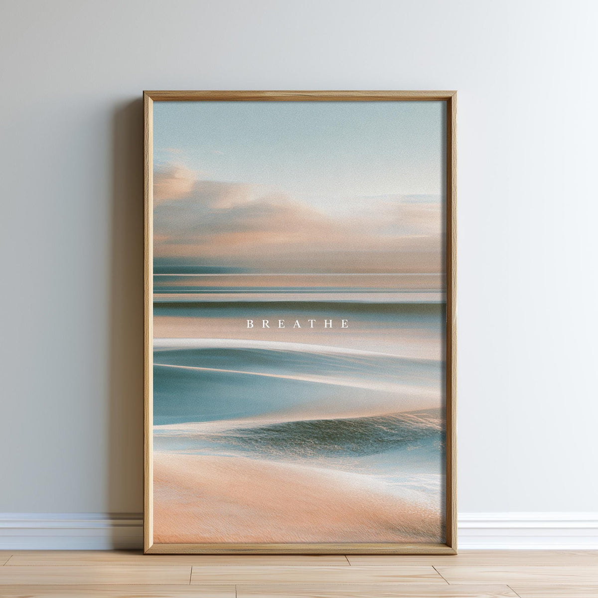 a framed picture of a serene beach scene with a calm ocean and a cloudy sky.
