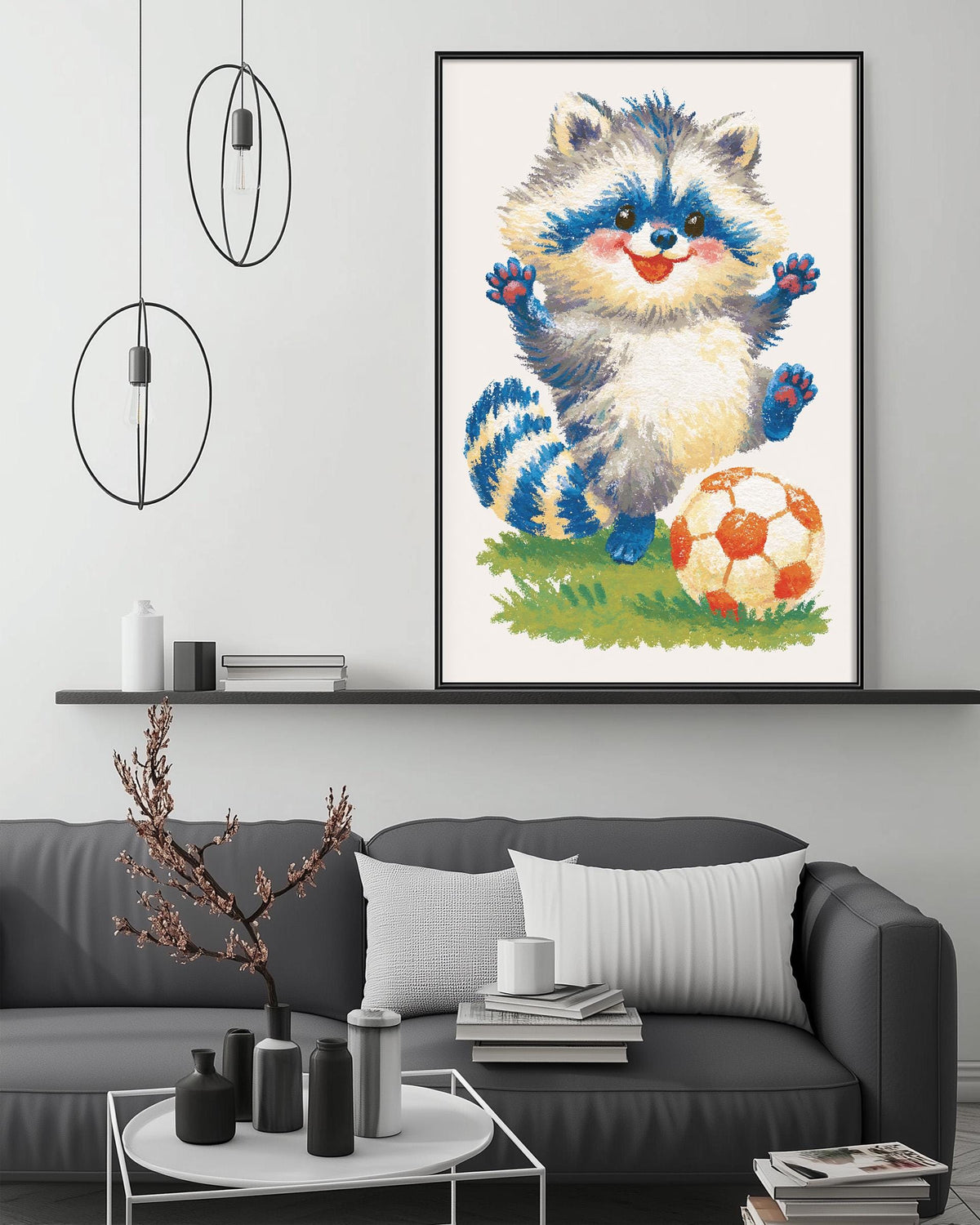 a cozy living room with a gray couch, a coffee table, and a framed illustration of a raccoon playing with a soccer ball.