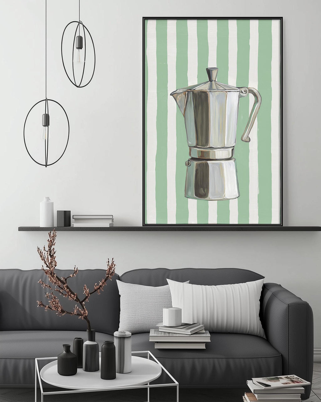 a modern living room with a gray sofa, a coffee table, and a framed artwork of a silver coffee maker on the wall.