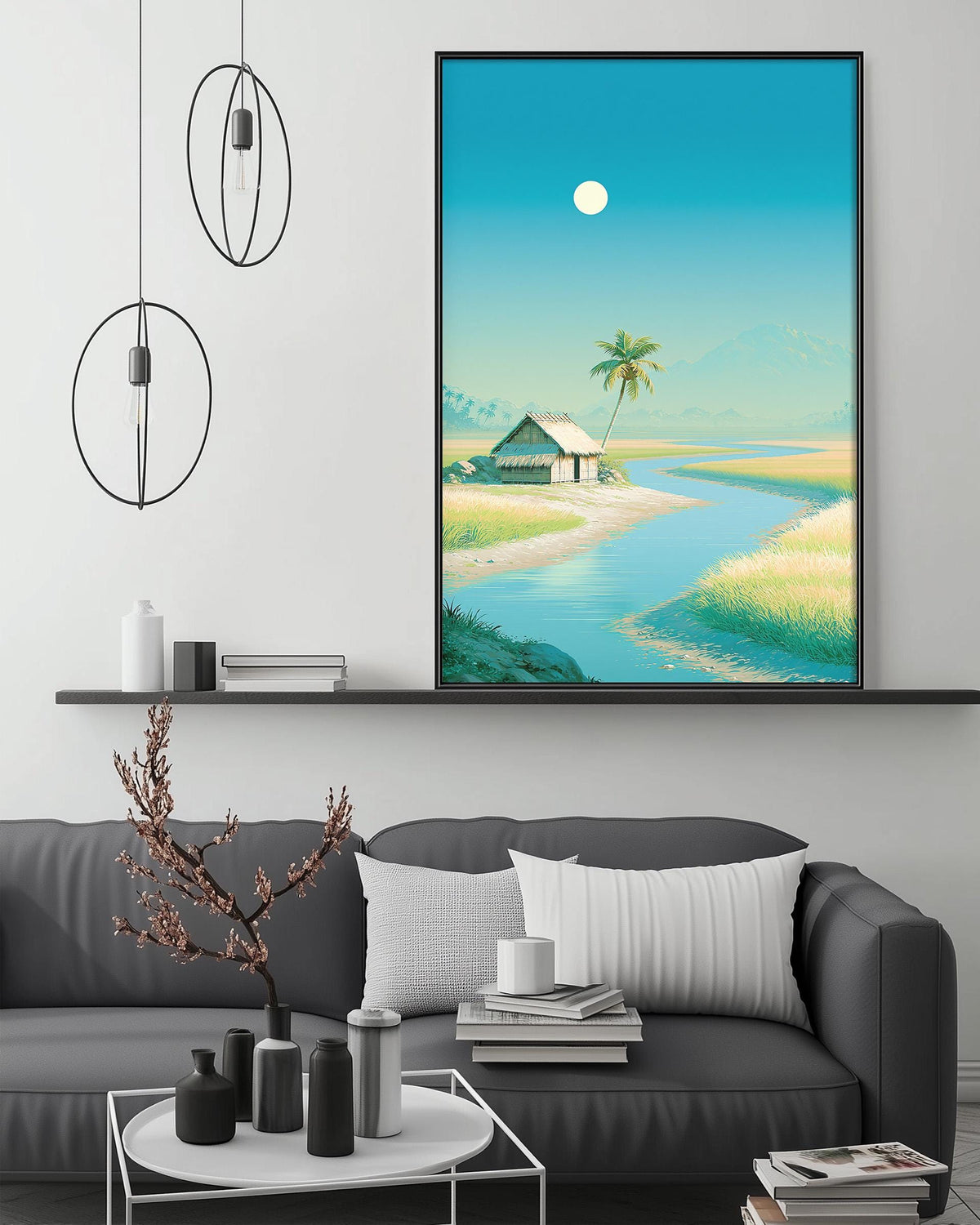 a living room with a gray sofa, a coffee table, and a large framed painting depicting a serene tropical landscape with a house, palm trees, and a river.