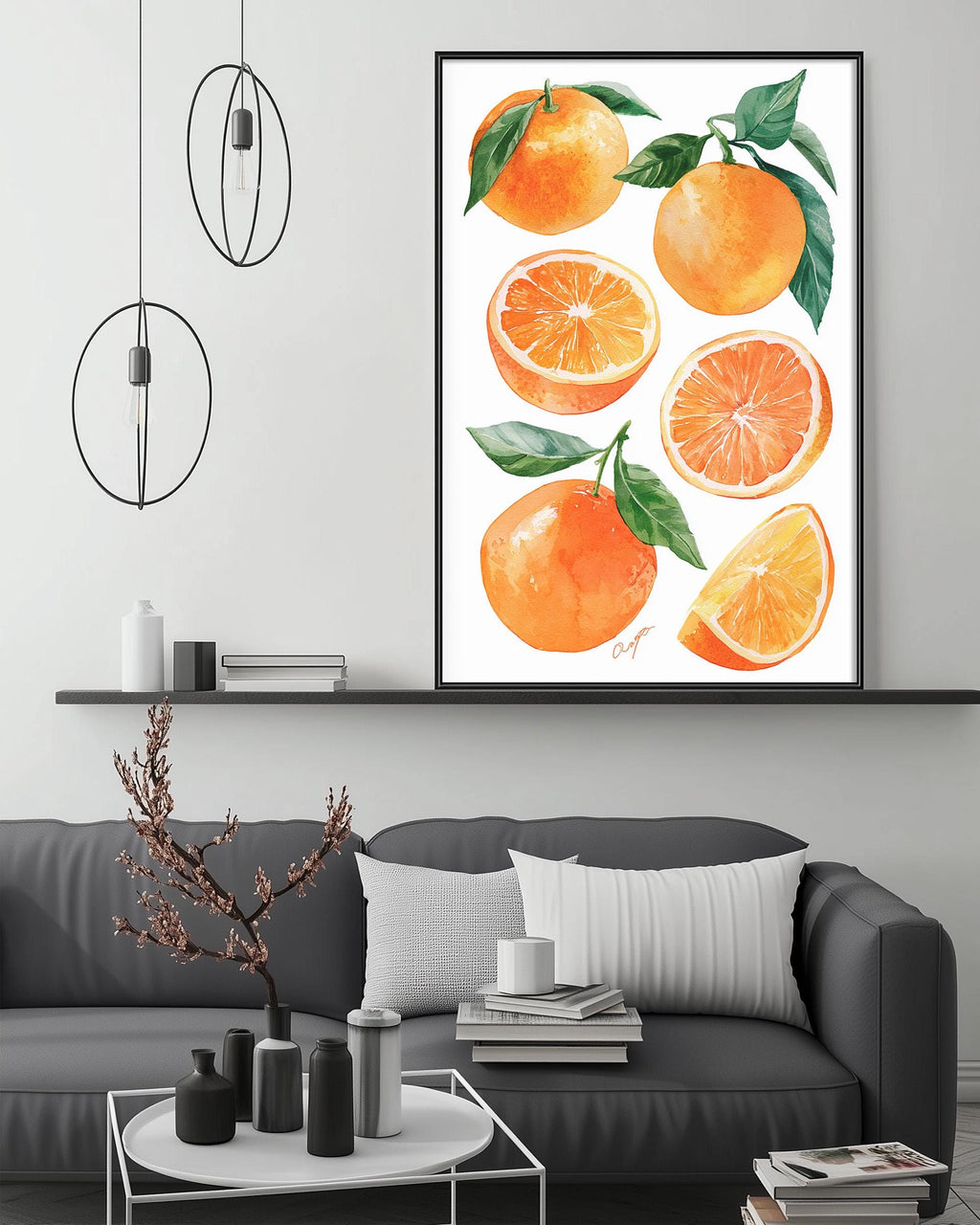 a modern living room with a gray sofa, a coffee table, and a framed print of oranges on the wall above it.