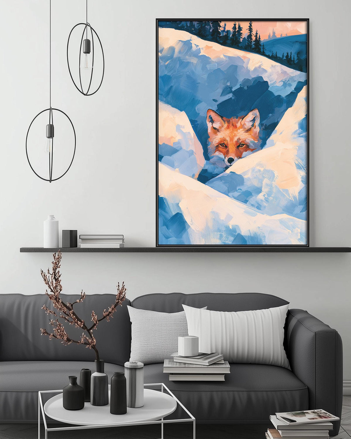 a cozy living room with a gray couch, a coffee table, and a large framed painting of a fox peeking out from the snow. The painting is hanging above the couch, creating a focal point in the room.
