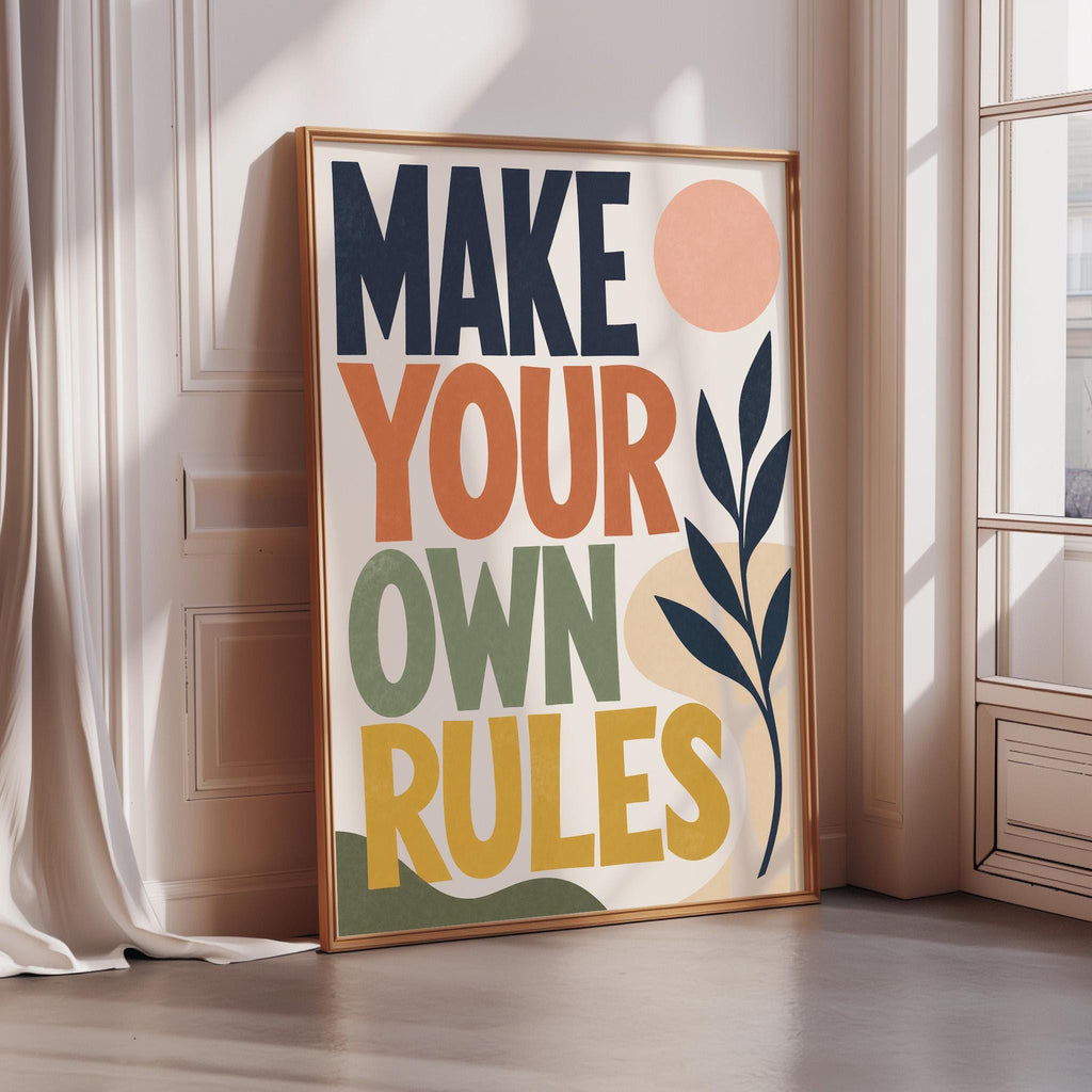 a framed poster with the text "MAKE YOUR OWN RULES" displayed prominently on it.