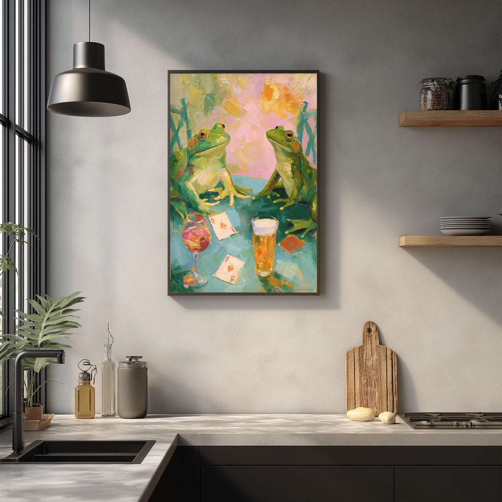 a vibrant painting of two green frogs sitting at a table, surrounded by various objects such as a wine glass, a cup, and a deck of cards. The painting is hung on a wall above a kitchen counter, which has a sink, a cutting board, and some other kitchen items.