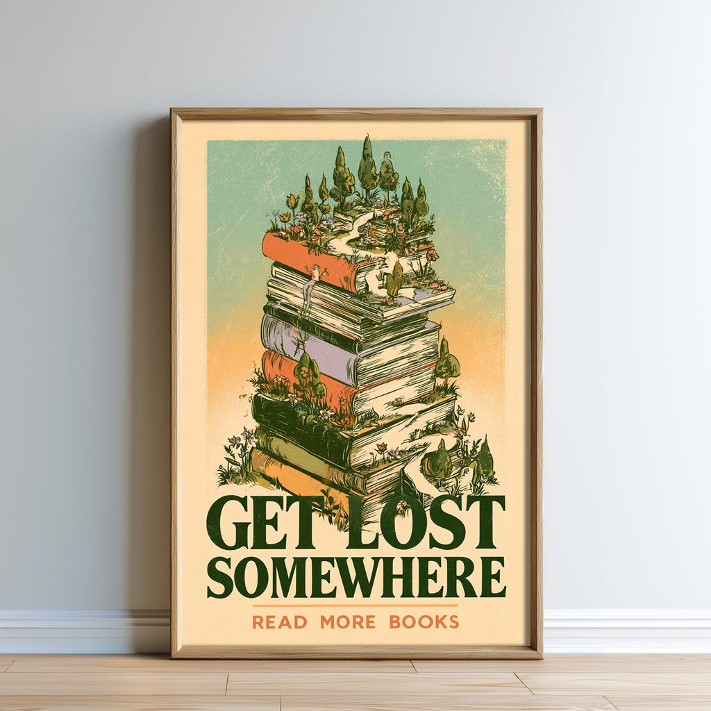 The image is a framed poster with a stack of books on top of it, surrounded by a forest scene. The poster has the text "GET LOST SOMEWHERE READ MORE BOOKS" written on it.