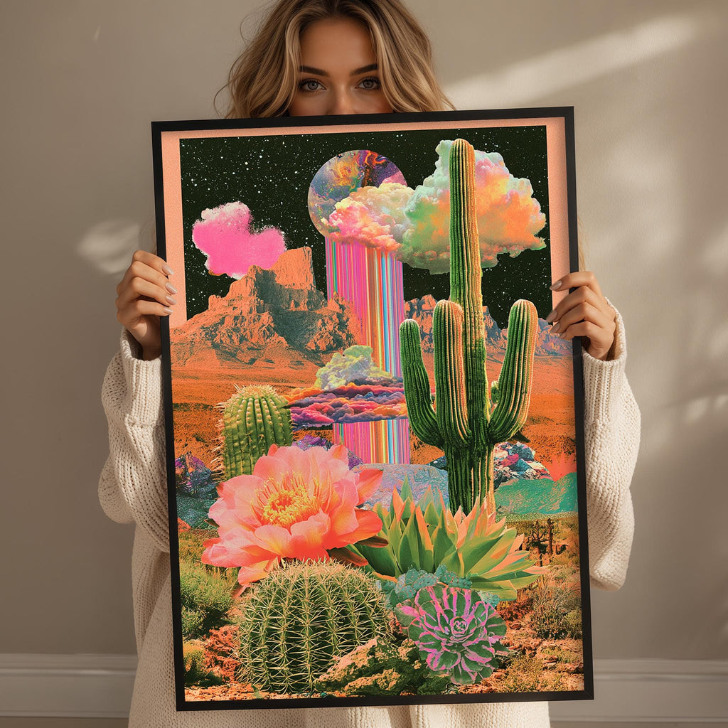 A woman holds up a framed collage depicting a desert landscape with cacti, a rainbow, and a moon.