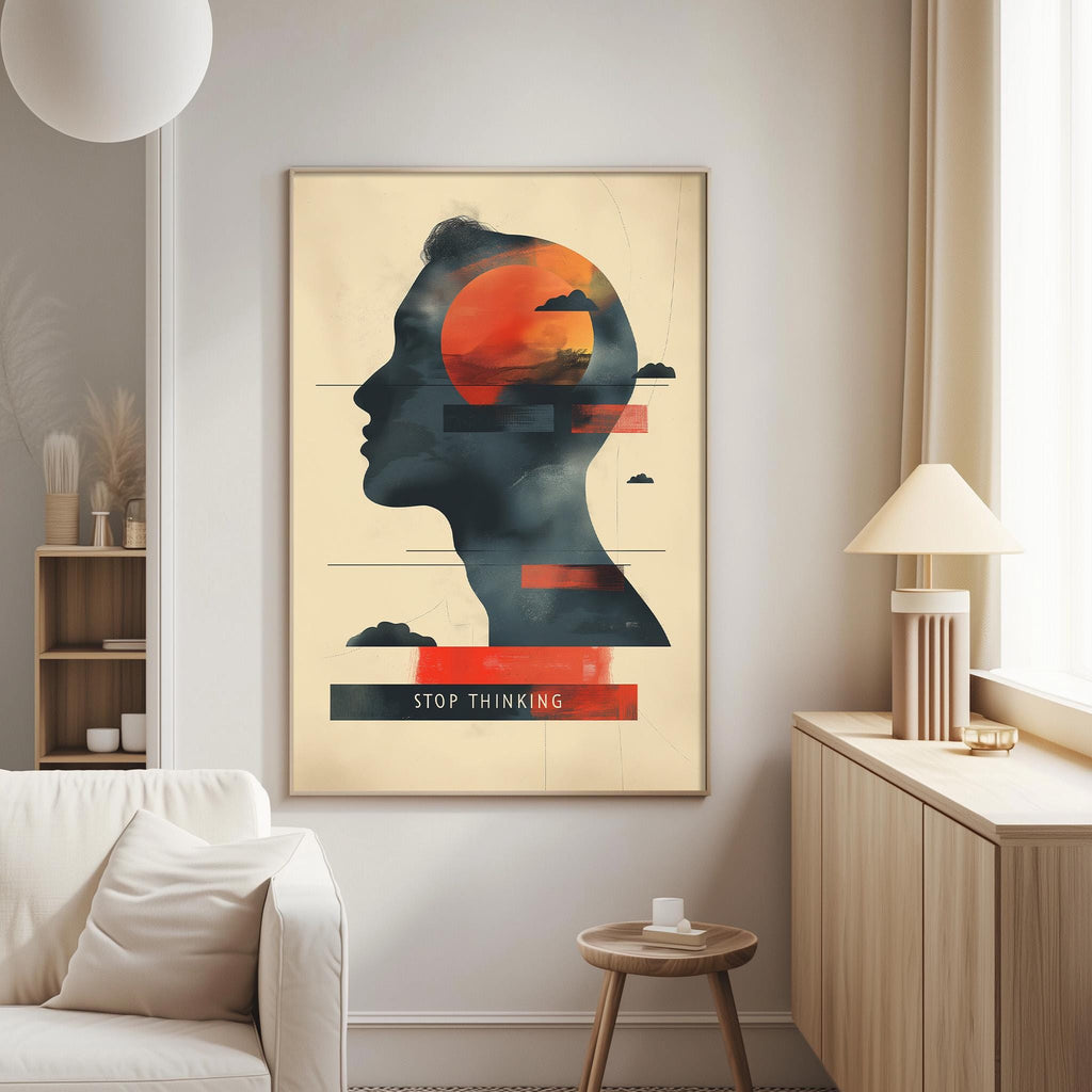 a poster with a silhouette of a person's head and the text "STOP THINKING" displayed on it. The poster is hanging on a wall in a living room setting, with a white couch and a lamp visible in the background.