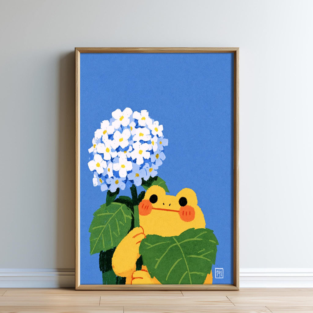 A framed illustration of a yellow frog holding a bunch of white flowers against a blue background.