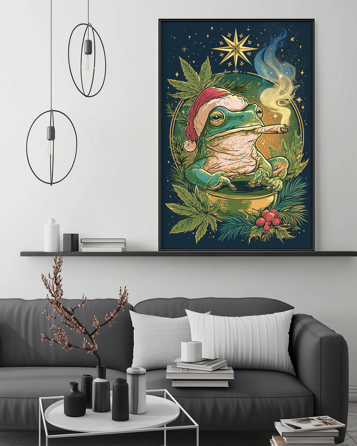 a large, colorful painting of a frog wearing a Santa hat, surrounded by greenery and a starry night sky. The painting is displayed on a wall above a gray couch, which has a coffee table in front of it. The room has a minimalist and modern decor, with pendant lights hanging above the couch and a bookshelf in the background.