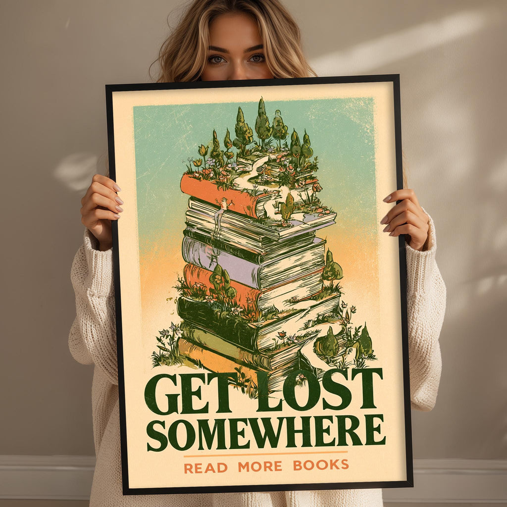 A woman holding a framed poster with a stack of books and a forest scene on it.