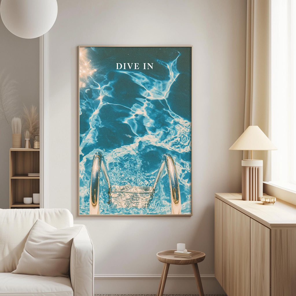 a large framed poster of a swimming pool with a ladder, hanging on a wall in a living room.