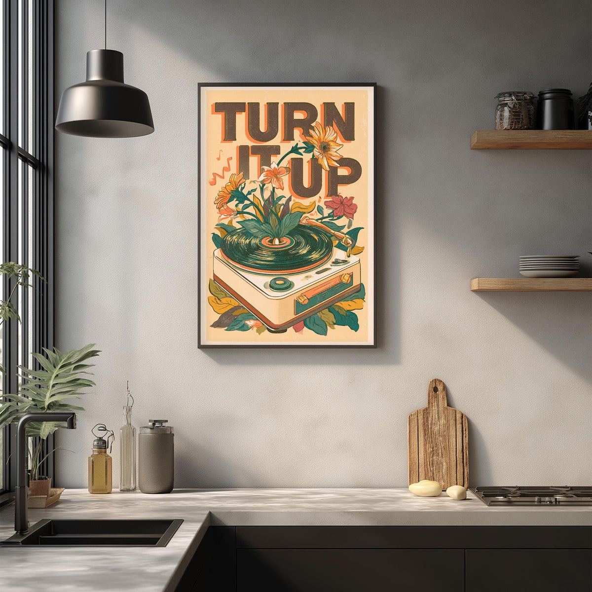 a framed poster with the text "TURN IT UP" hanging on a wall above a kitchen counter.