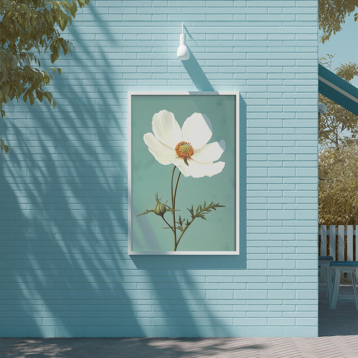a large white flower with a yellow center, hanging on a blue brick wall.