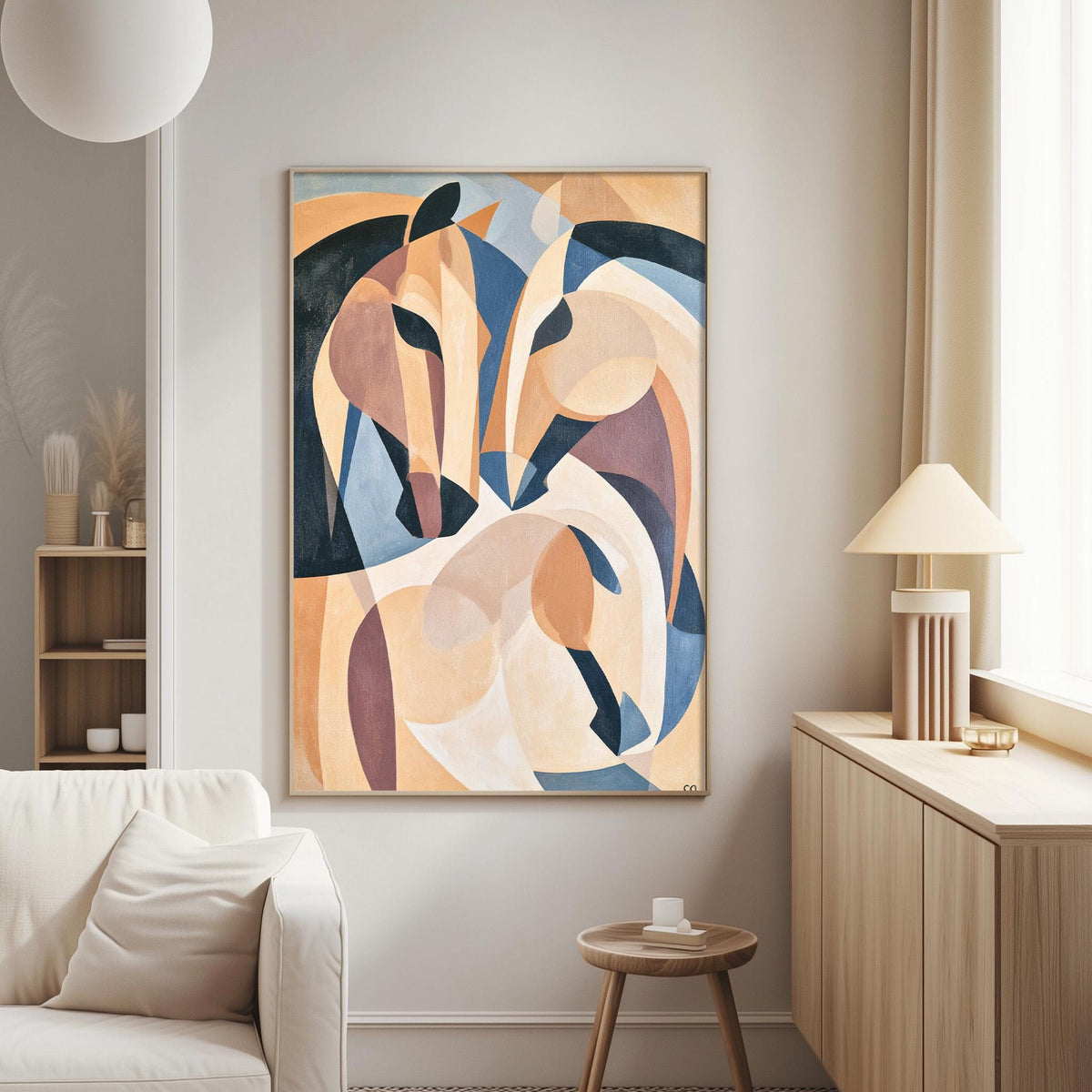 a modern living room with a large abstract painting of two stylized horses on the wall. The painting is framed in a wooden frame and hangs above a white sofa. To the right of the painting, there is a wooden side table with a lamp on top. The room has a minimalist and contemporary design, with a large window providing natural light.