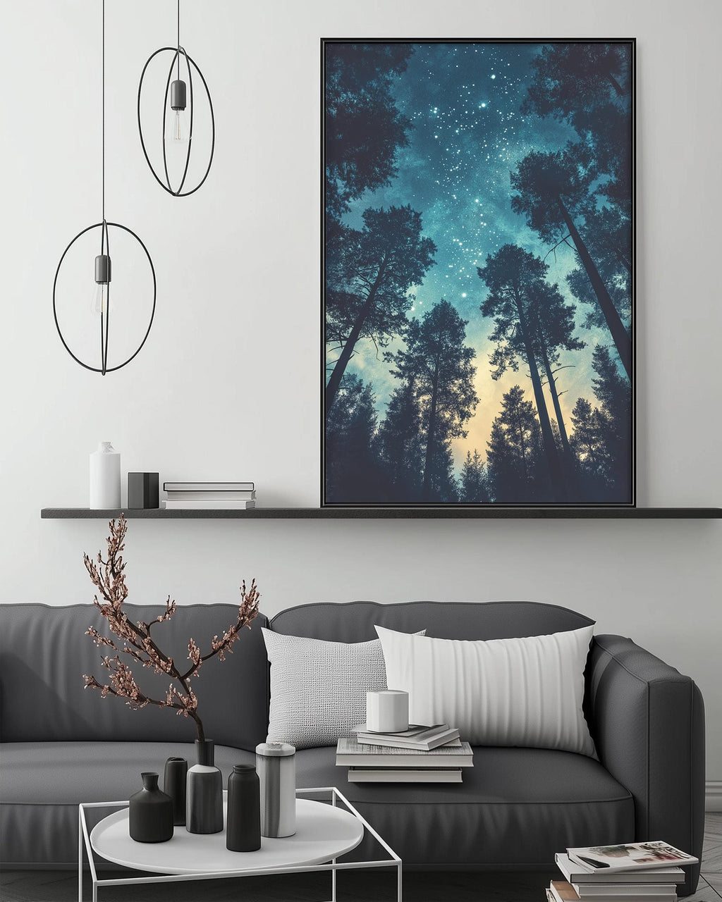 a modern living room with a gray sofa, a coffee table, and a large framed picture of a forest scene hanging on the wall above the sofa.