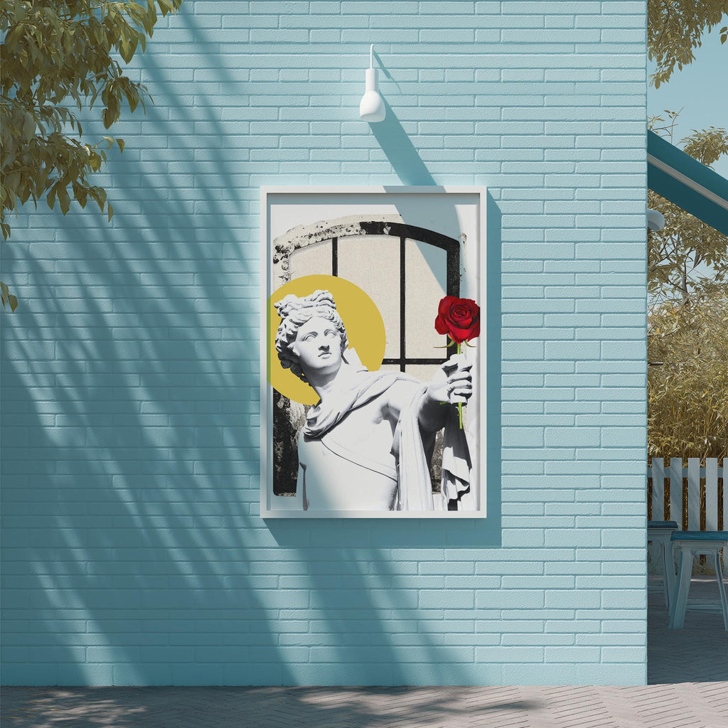 a framed artwork of a statue of a woman holding a red rose, mounted on a blue wall.
