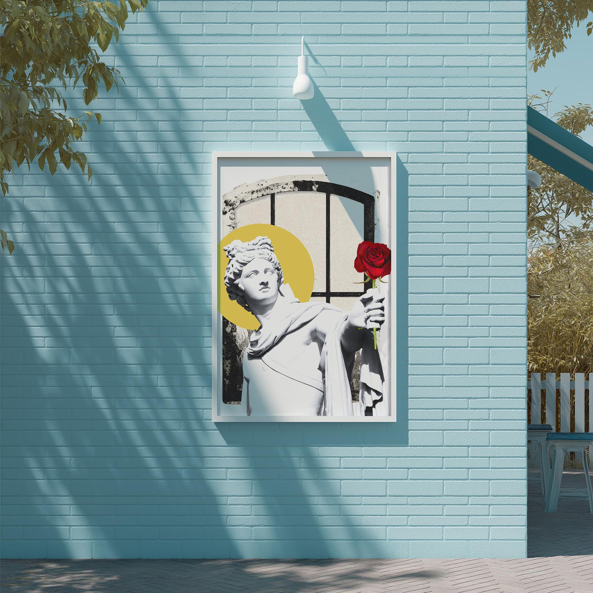 a framed artwork of a statue of a woman holding a red rose, mounted on a blue wall.