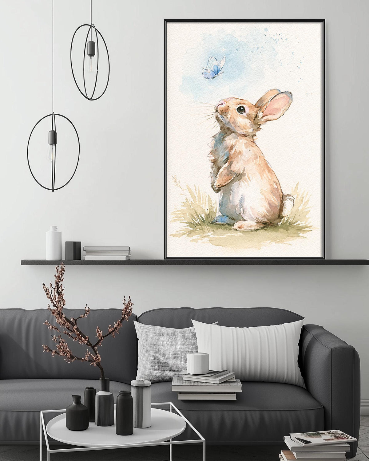 a cozy living room with a gray sofa, a coffee table, and a large framed painting of a rabbit sitting in the grass. The painting depicts a rabbit looking up at a blue butterfly in the air.