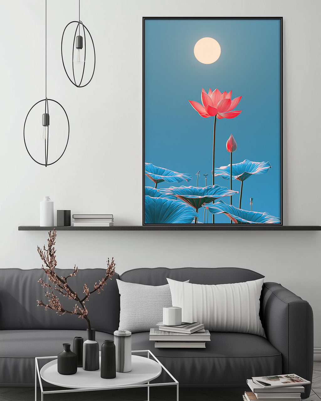 a large framed picture of a lotus flower with a full moon in the background, hanging on a wall above a gray couch with a coffee table in front of it.