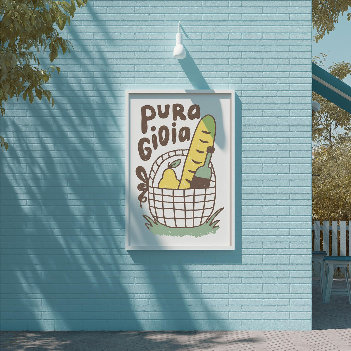 a blue brick wall with a framed poster or sign hanging on it. The poster has a cartoon illustration of a basket with various fruits and vegetables, including a banana and an apple. The text on the poster reads "Pura Gioia".