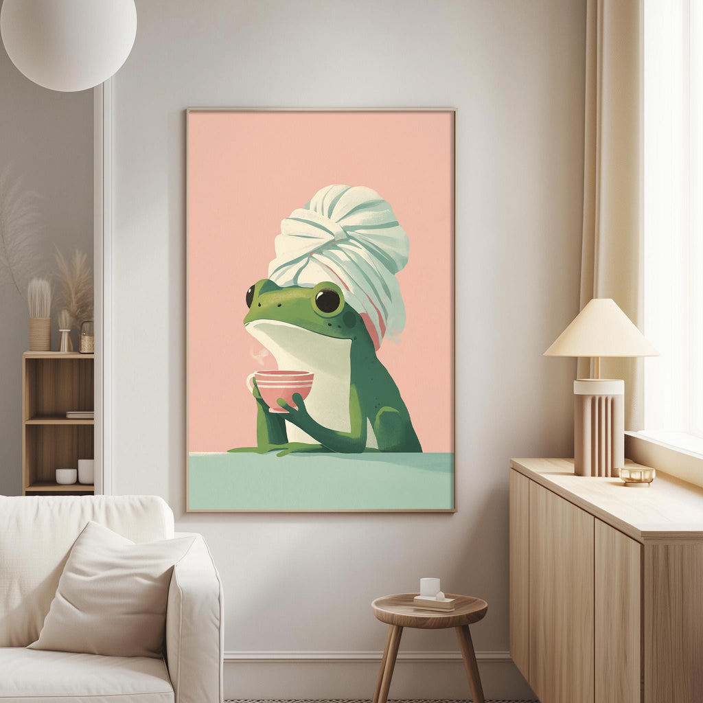 a cozy living room with a large framed poster of a frog wearing a white towel and holding a pink cup, sitting on a green surface. The poster is hanging on the wall, and there is a white couch and a wooden side table in the room.