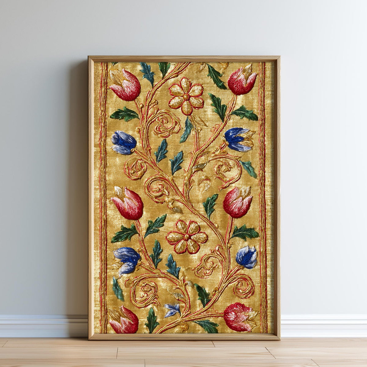 a framed artwork with a gold border and a floral design in red, blue, and green colors.