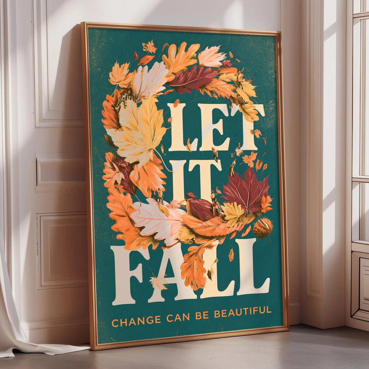 A framed poster with a vibrant autumn design and the text "LET IT FALL" prominently displayed.
