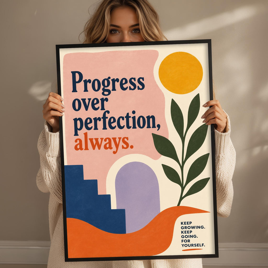 A woman holding a framed poster with a motivational message about progress and self-growth.