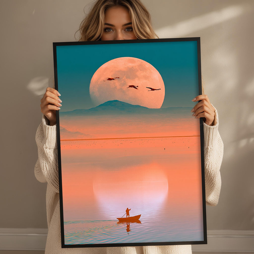 A woman holds up a framed image depicting a serene scene of a person in a boat on a calm body of water, with a large, glowing moon in the background.