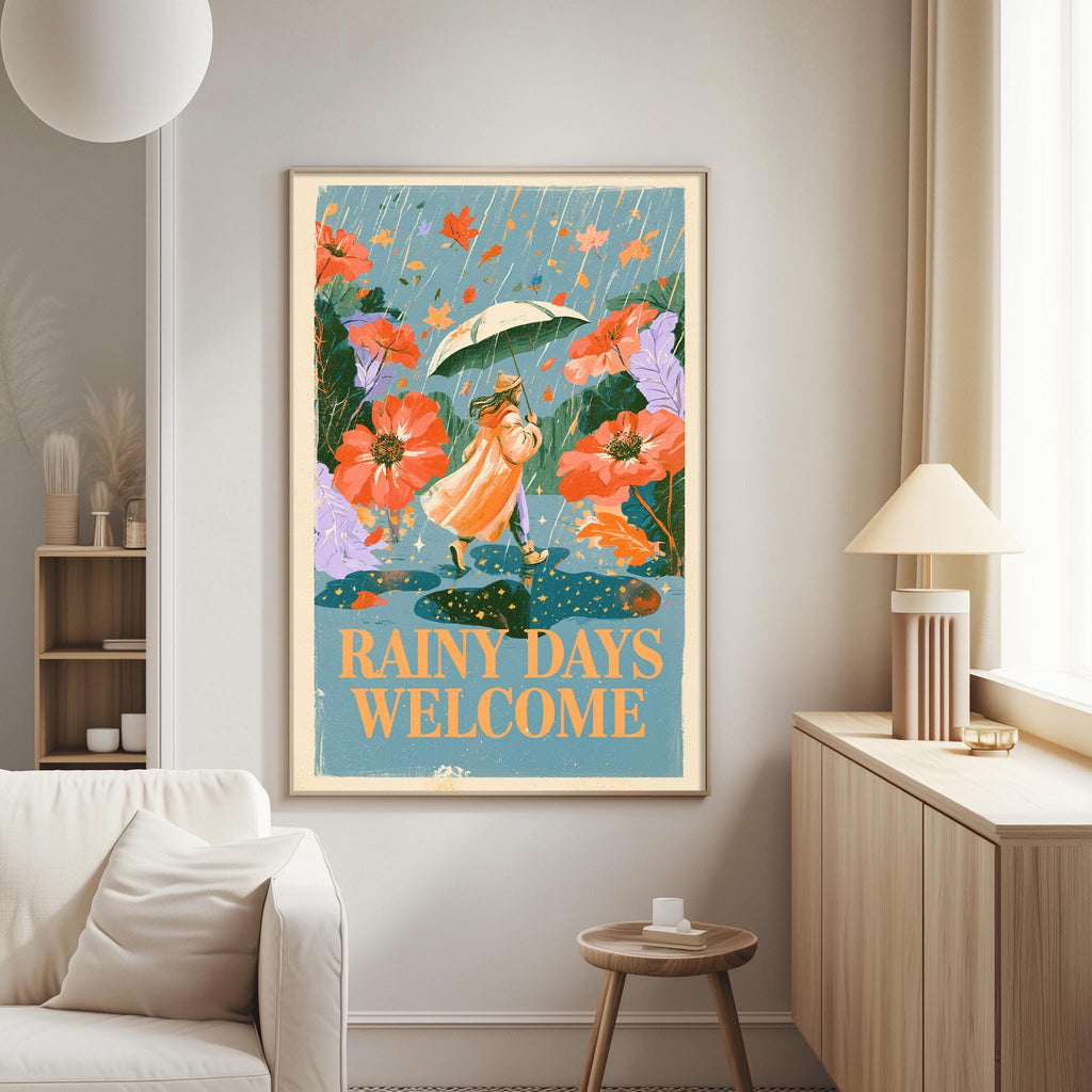 a framed poster with a woman holding an umbrella and surrounded by flowers, with the text "RAINY DAYS WELCOME" displayed on the poster.
