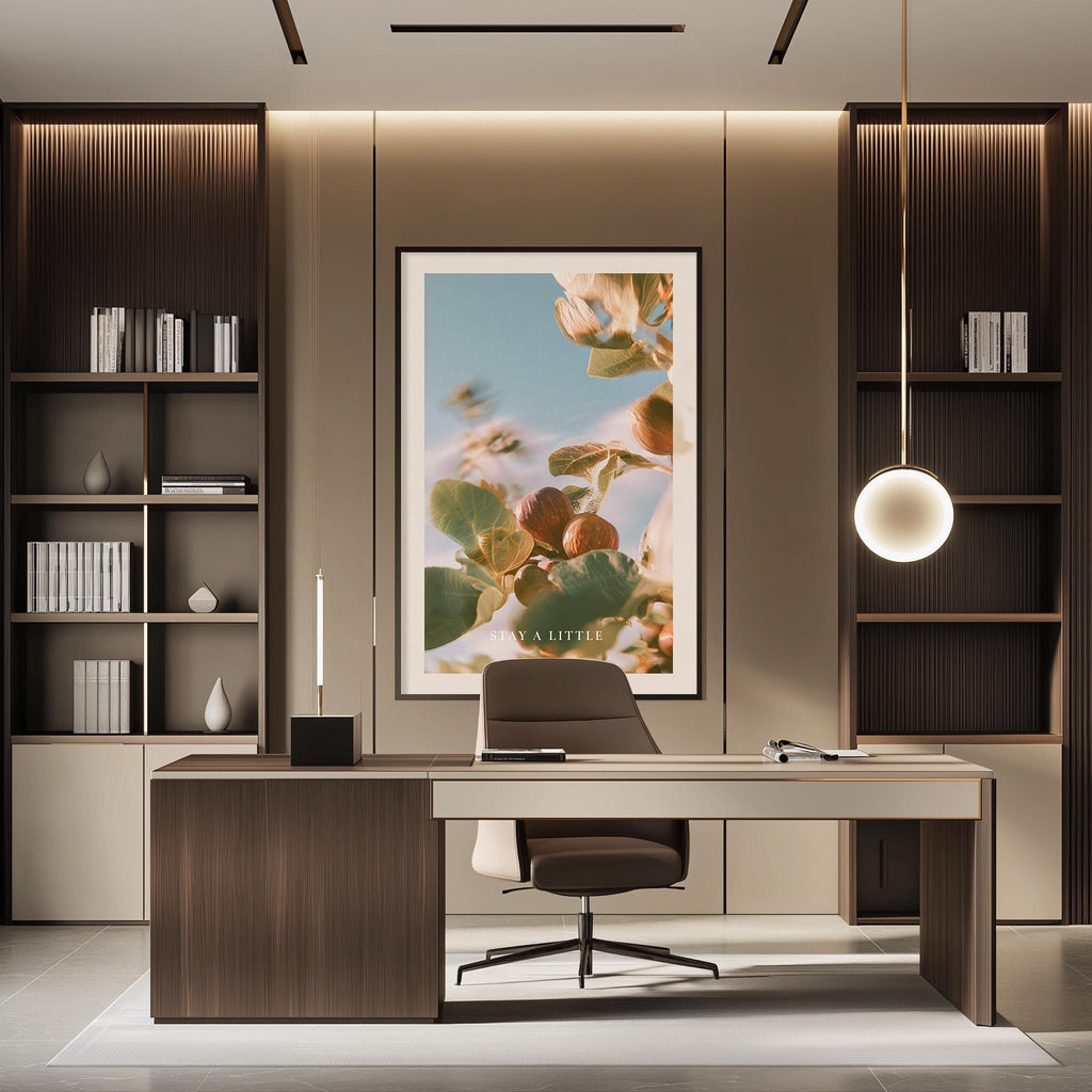 a modern and well-organized office space with a large framed artwork featuring a floral design on the wall. The office features a wooden desk, a comfortable-looking chair, and a pendant light above the desk, creating a warm and inviting atmosphere.