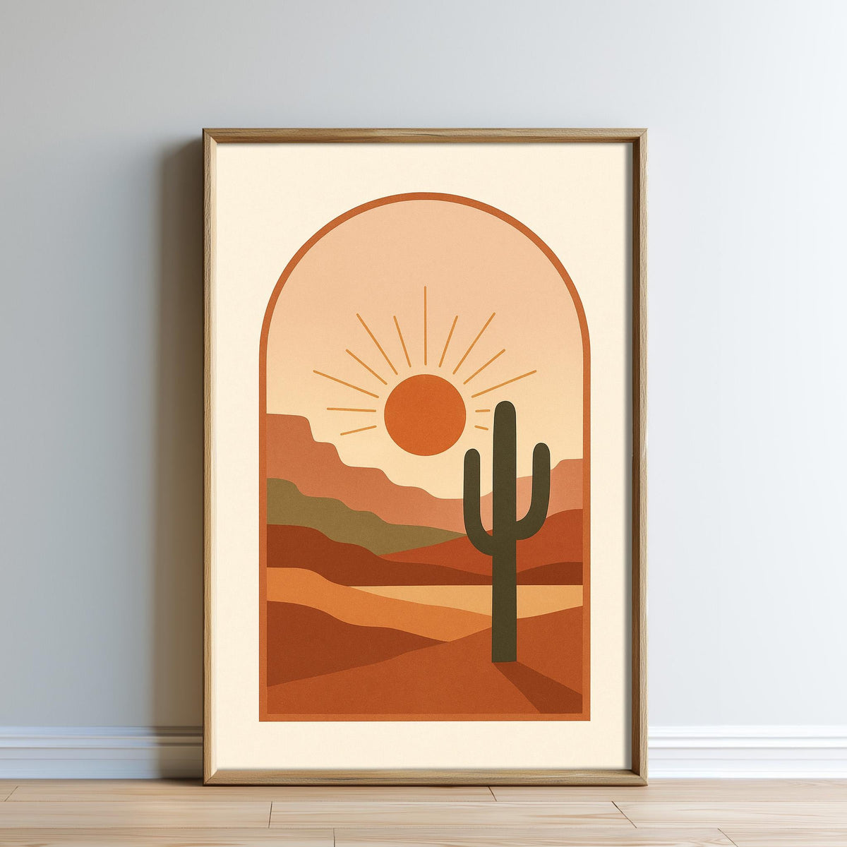 The image is a framed print depicting a desert landscape with a cactus in the foreground and a sun-filled sky in the background.