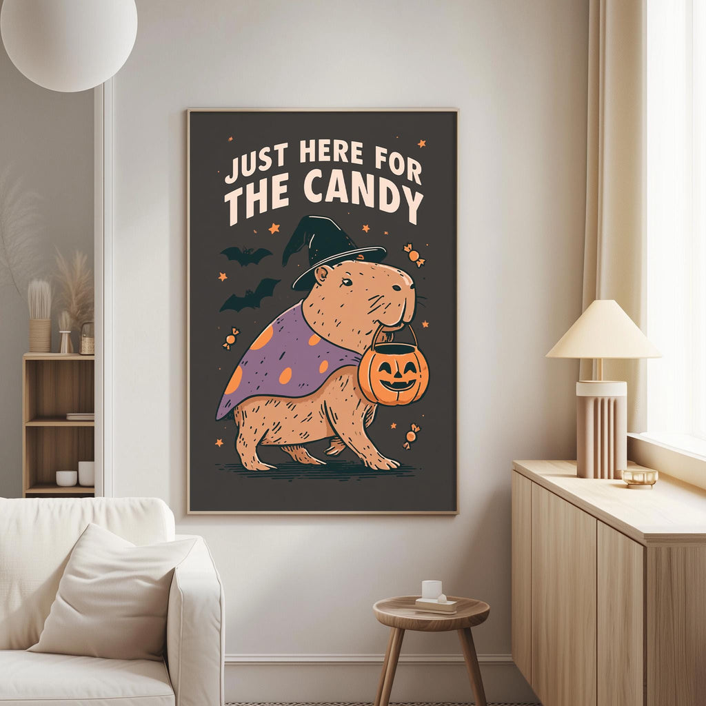 a poster with a cartoon image of a beaver dressed as a witch, holding a carved pumpkin, and the text "Just here for the candy" above it.