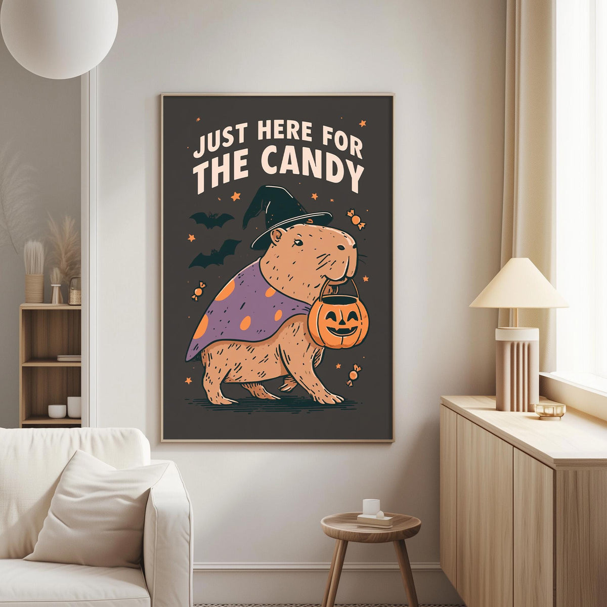 a poster with a cartoon image of a beaver dressed as a witch, holding a carved pumpkin, and the text "Just here for the candy" above it.