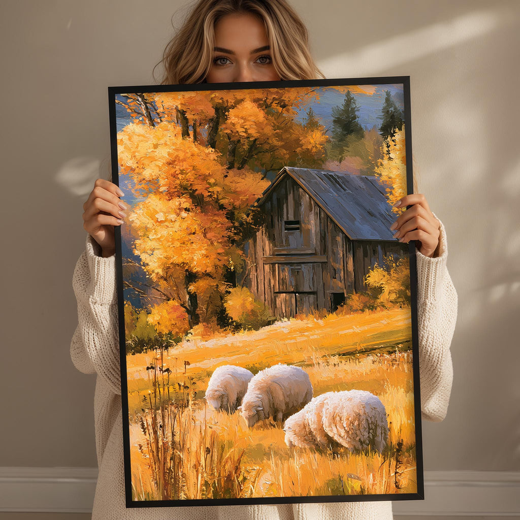 A woman holds up a framed painting depicting a rustic barn surrounded by a field of golden grass and trees with autumn foliage.