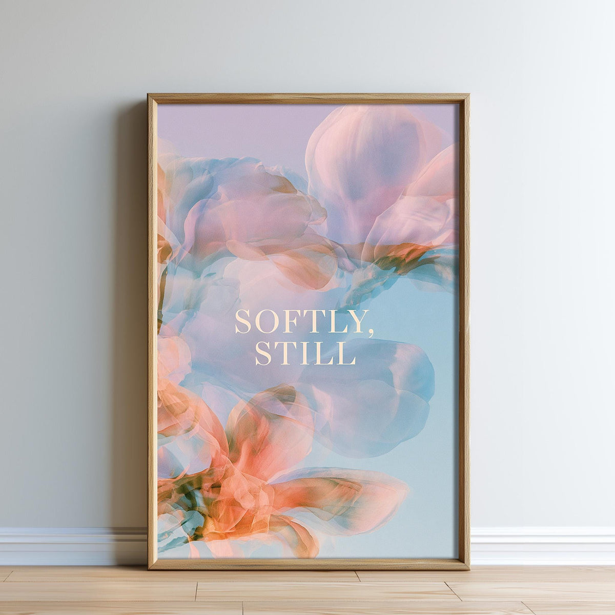 The image is a framed poster with a floral design and the text "Softly, Still" written on it.