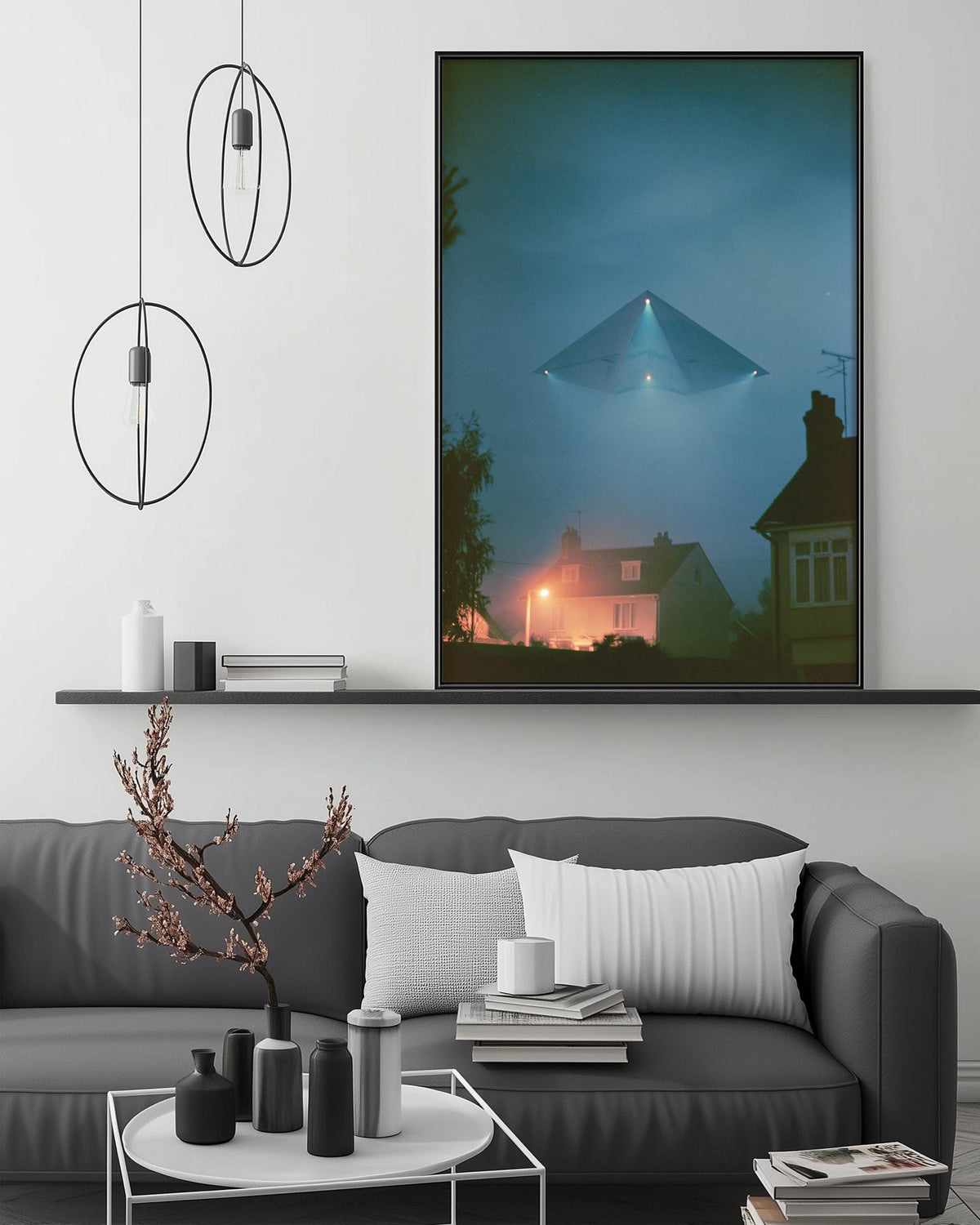 a modern living room with a gray sofa, a coffee table, and a large framed picture of a distant city skyline at night.
