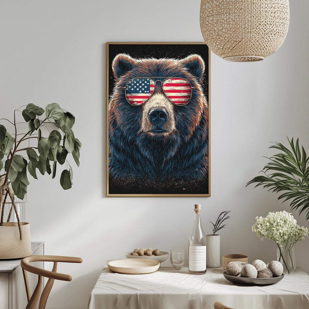 a framed painting of a bear wearing sunglasses with an American flag design, hanging on a wall above a dining table with various items on it.